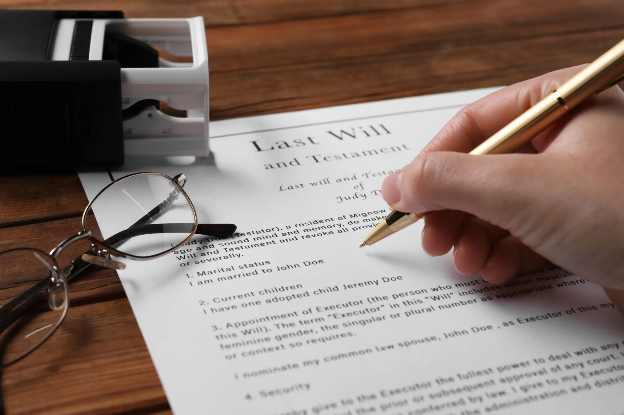 Woman signing Last Will and Testament at wooden table, closeup Woman signing Last Will and Testament at wooden table, closeup