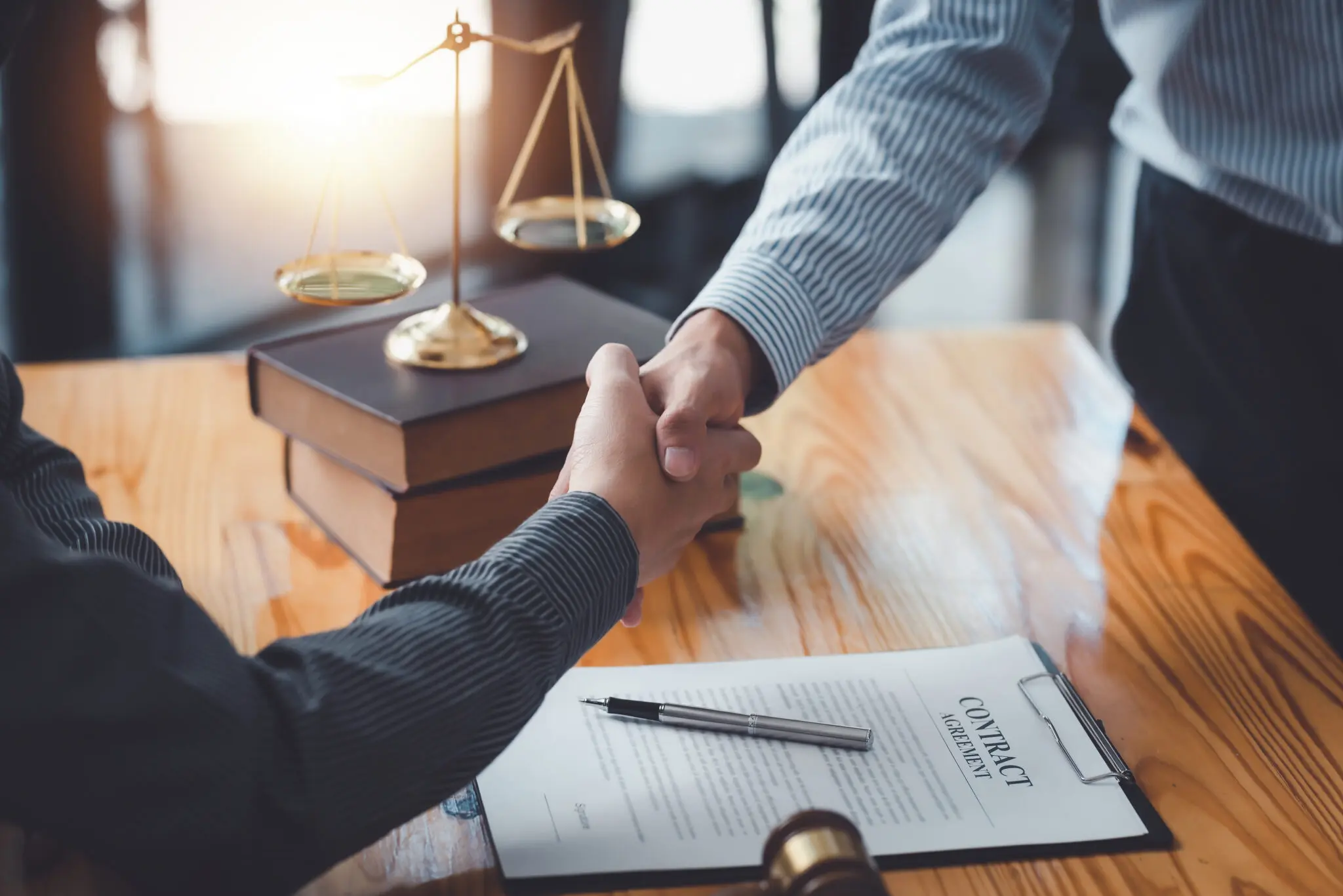 Businessman shaking hands partner lawyers or attorneys discussing a contract agreement. Businessman shaking hands partner lawyers or attorneys discussing a contract agreement.
